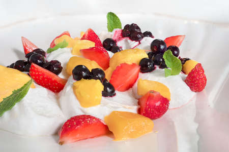 Summer breakfast dessert with fresh fruits on ice cream or yogurt healthy diet food vitamin-rich....