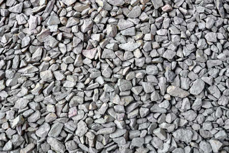 Crushed rock close up. Small rocks ground. Crushed stone road building material gravel texture....