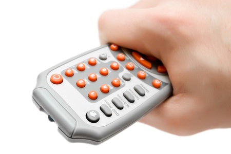 Close up of a hand holding a remote control.の写真素材