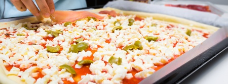Creating a homemade pizza with natural ingredients の写真素材