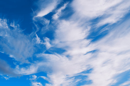 Sky landscape of cloudy sunset sky. Blue sky background with white clouds lit by sunny light in good weatherの写真素材