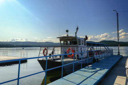 MIASS, RUSSIA - AUGUST 13, 2009. Avtozavodets pleasure boat is docked on Lake Turgoyak in summer sunny day, Southern Uralsのeditorial素材
