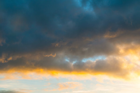 Blue dramatic sunset sky background - picturesque colorful clouds lit by sunlight. Vast sky...