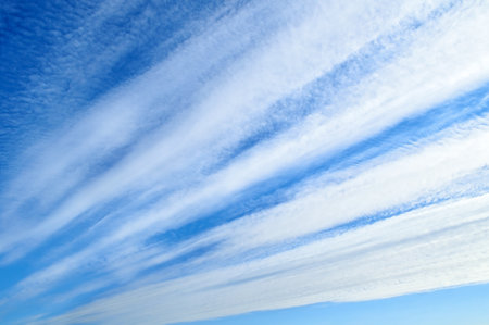 Blue sky background with white straight clouds in good weather- natural sky background with sunlightの写真素材