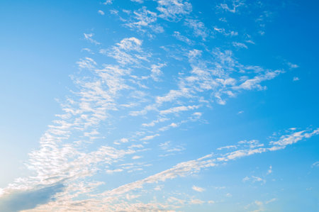 Blue sky sunset landscape with dramatic clouds lit by evening sunset light - colorful evening sky...