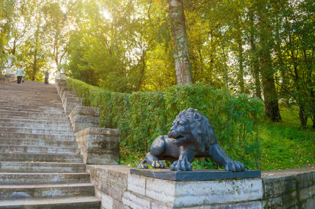 PAVLOVSK, RUSSIA - SEPTEMBER 21, 2017. Large stone staircase and sculpture of a black lion on the pedestal in Pavlovsk park, St Petersburg Russiaのeditorial素材
