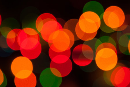 Christmas lights background, festive Christmas multicolor bokeh background. Holiday glowing color...