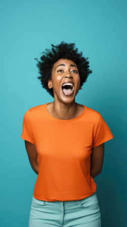 Young african american woman wearing casual clothes shouting and mad crazy doing yelling with arms aggressive and mouth closed up screaming aggressive concept.の素材