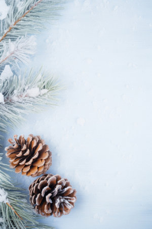 Christmas background with pine branches and cones on white snow. christmas card, flat lay, copy space.の写真素材