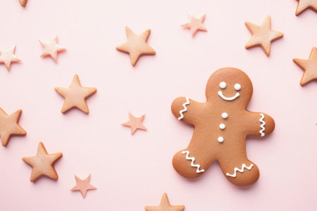 Christmas gingerbread cookie and stars on pink background. christmas concept. top view flat lay....