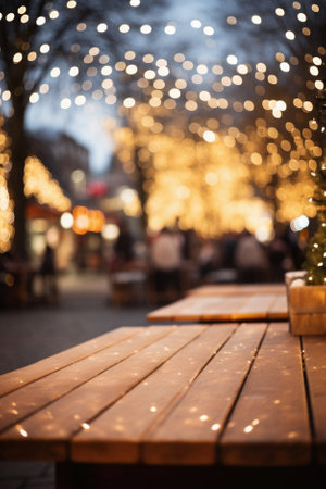 Empty wooden table in front of christmas market in the city with bokeh.の素材