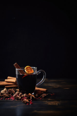 Mulled wine with spices on wooden background.の写真素材