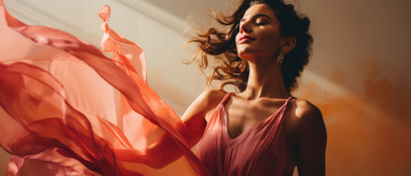 Beautiful young woman in elegant dress with flying fabric.の素材