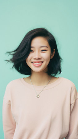Portrait of a beautiful young Asian woman smiling and looking at camera.の素材