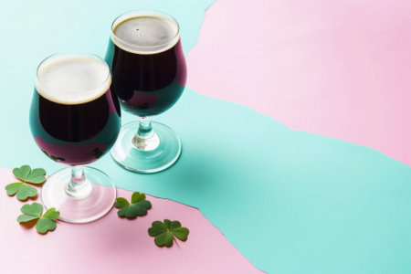 Glass pint of cold draft light lager or dark ale brewed beer with foam on table background. Brewery or pub bar advertising. Oktoberfest festival alcohol beverage or Saint Patricks day drink concept.の素材