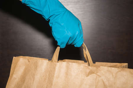 The delivery courier transmits the package contactlessly.