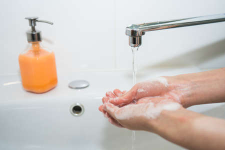 Hand washing with soap. Girl washes her hands with antibacterial soapの写真素材