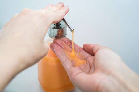 Hand washing with soap. Girl washes her hands with antibacterial soapの写真素材