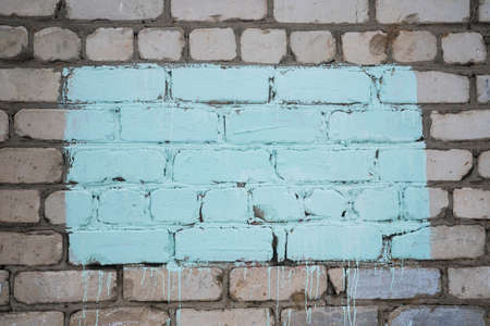 blue rectangle on a brick wall. Colored place for text. High quality photoの写真素材