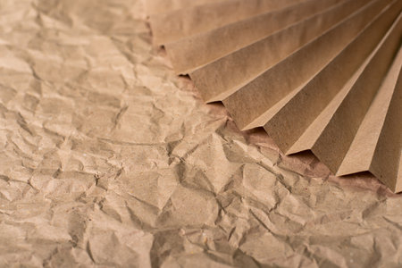 Background of crumpled and corrugated brown paper from fallen leavesの写真素材