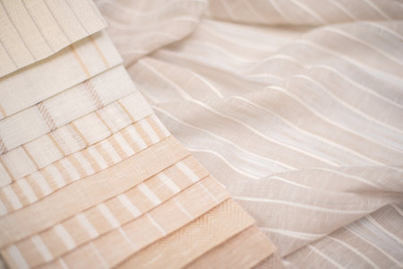 A palette of linen fabric with different stripes in beige tones. Fabric for curtains and tulles.の写真素材