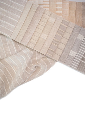 A palette of linen fabric with different stripes in beige tones. Fabric for curtains and tulles.