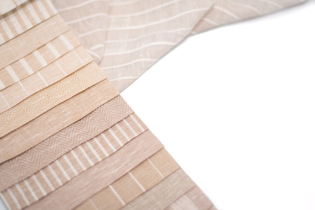 A palette of linen fabric with different stripes in beige tones. Fabric for curtains and tulles.