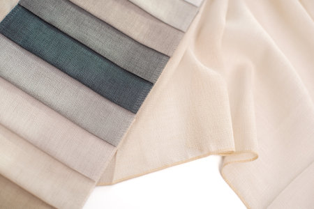Thin mesh fabric for curtains in beige and gray tones. Fabric for tulle on white background.
