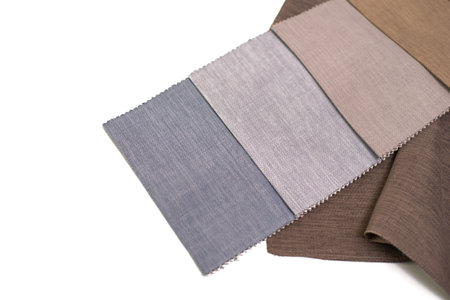 Fabric samples for curtains in beige, brown and blue colors on a white background.