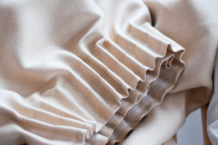 Collected beige curtain, folds on the curtain.