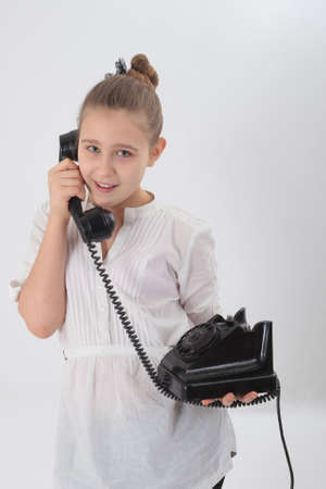 girl with old phone in the hands ofの写真素材