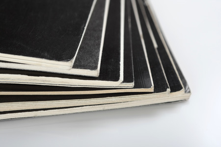 close-up of stacked magazine on a white backgroundの写真素材