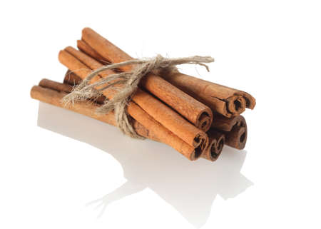 cinnamon sticks tied with rope on white background isolateの写真素材