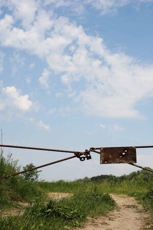 chain with a lock on the gate on the meadowの写真素材