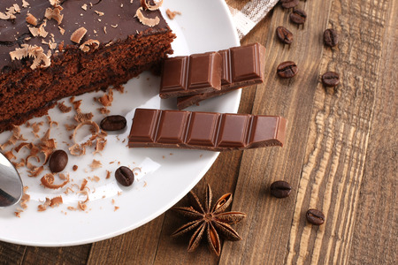 chocolate cake and chocolate in a bowl on a wooden boards backgroundの写真素材
