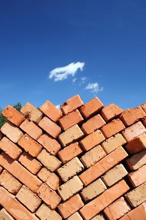 clay bricks stacked. against the blue sky