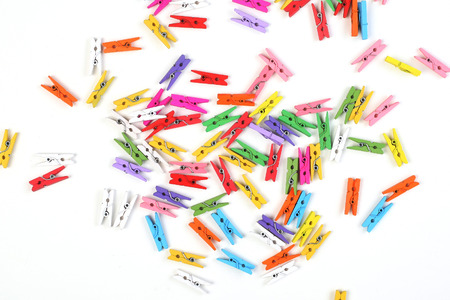beautiful clothespins scattered on a white backgroundの写真素材