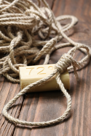 a loop of rope and soap close-up on a background of wooden planksの写真素材