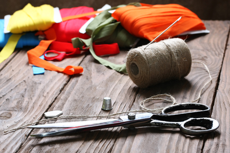 scissors and twine reel on the background of wooden boardsの写真素材