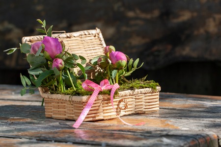 wicker box for wedding rings with beautiful flowers and natural mossの写真素材