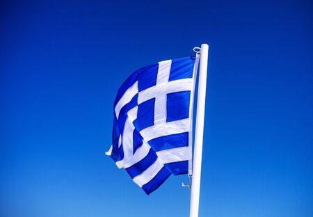 The Greek flag waving in the windの写真素材