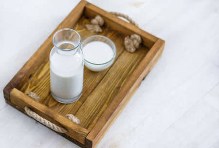 Glass of tasty rice milk on wooden table. Healthy and tasty natural drinkの写真素材