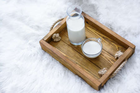 Glass of tasty rice milk on wooden table. Healthy and tasty natural drinkの写真素材