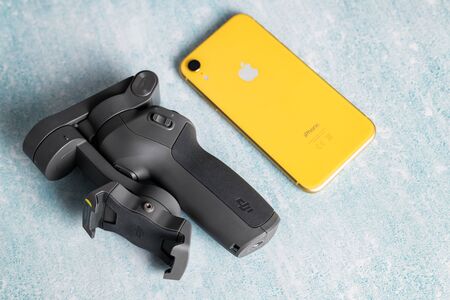 2.02.2020 - Kyiv, Ukraine. Mobile stabilizer DJI Osmo Mobile 3 with iphone xr on isolated background