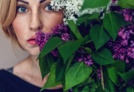 Spring bouquet of lilacs in woman hands. Woman portrait
