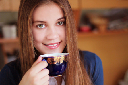 Girl with a cup of drink in handの写真素材