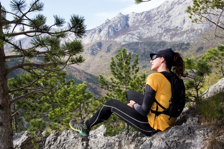 A woman hiker sitting on a gravel. National park Paklenica, the part of Velebit; the largest mountain range in Croatia.の写真素材