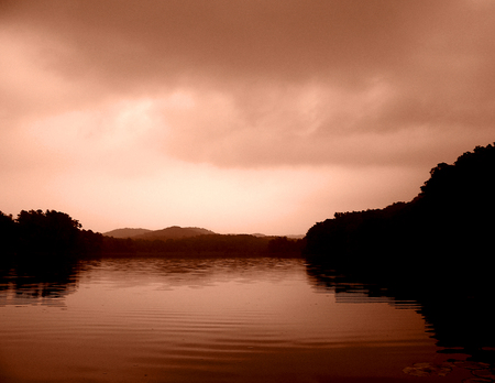 A larger lake on an overcast day during sunset.の写真素材
