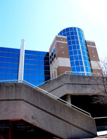 Clean blue windows reflect the sky making the building appear more blue.の写真素材