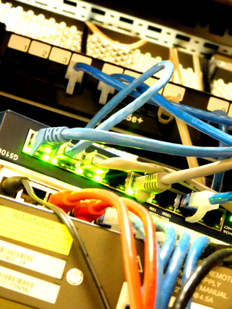 The back side of a server cabnet busy completing tasks.の写真素材